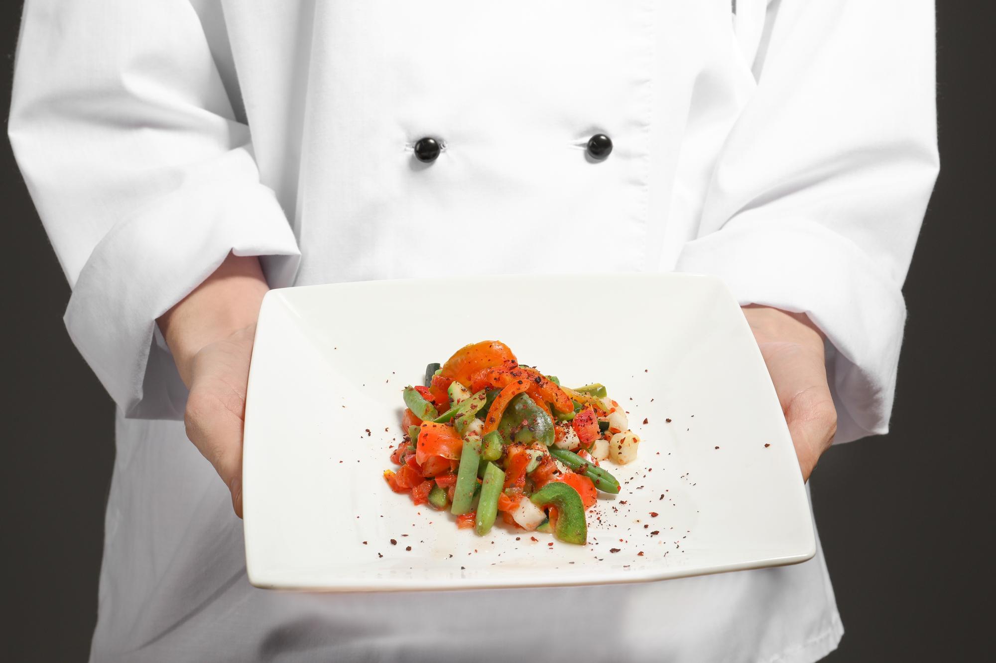 Instructor arranging plated dishes on a counter