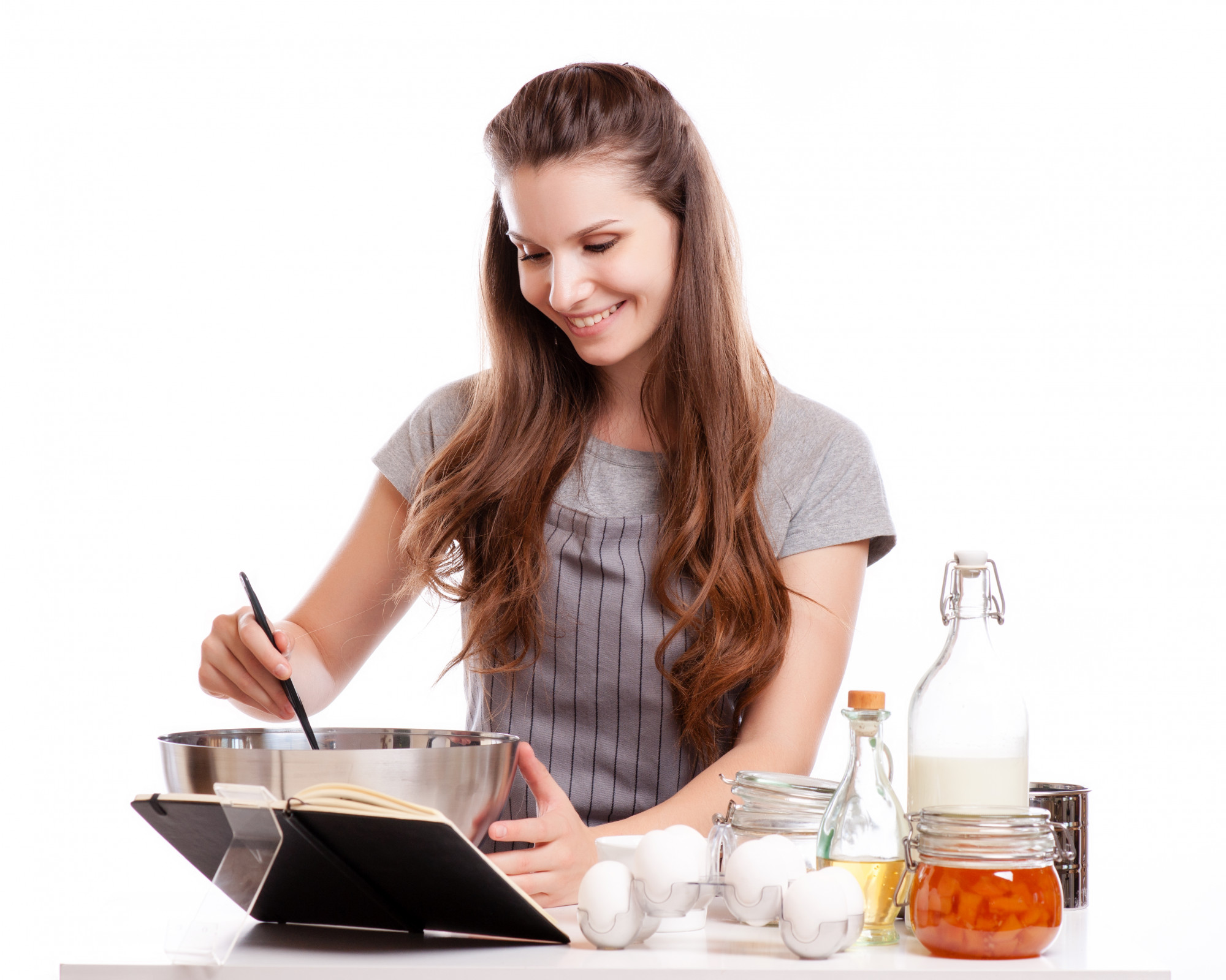 Student cooking in a small class supervised by instructor