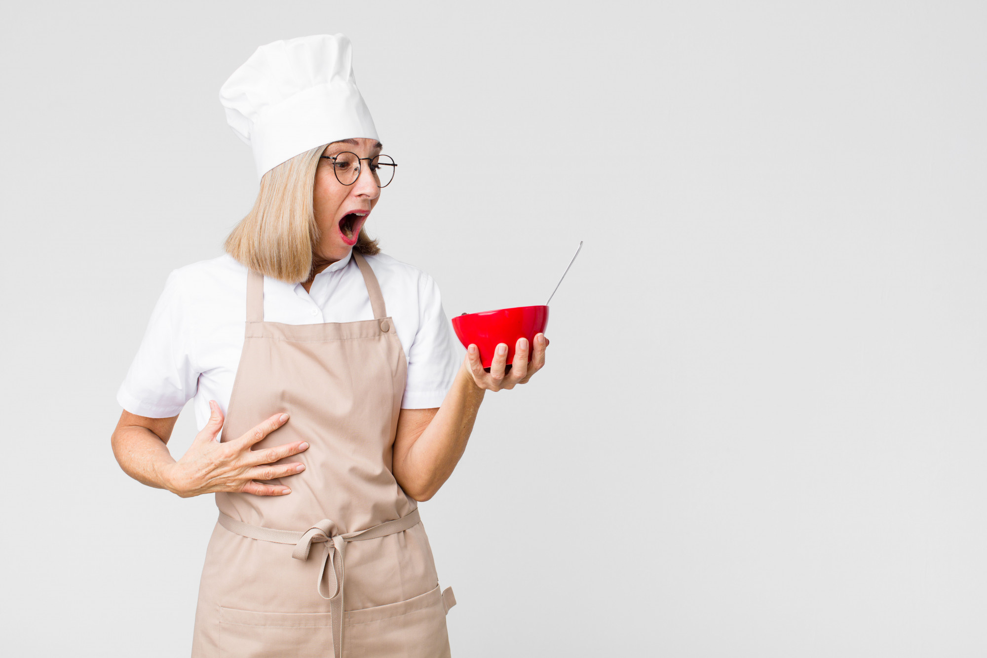 Student tasting a sauce with instructor feedback